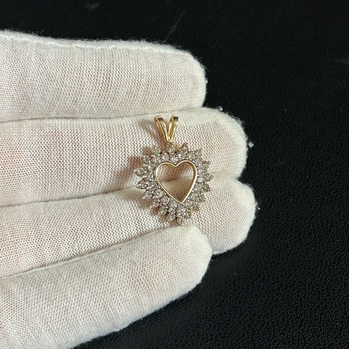Heart-shaped diamond ring on a white glove against a black background